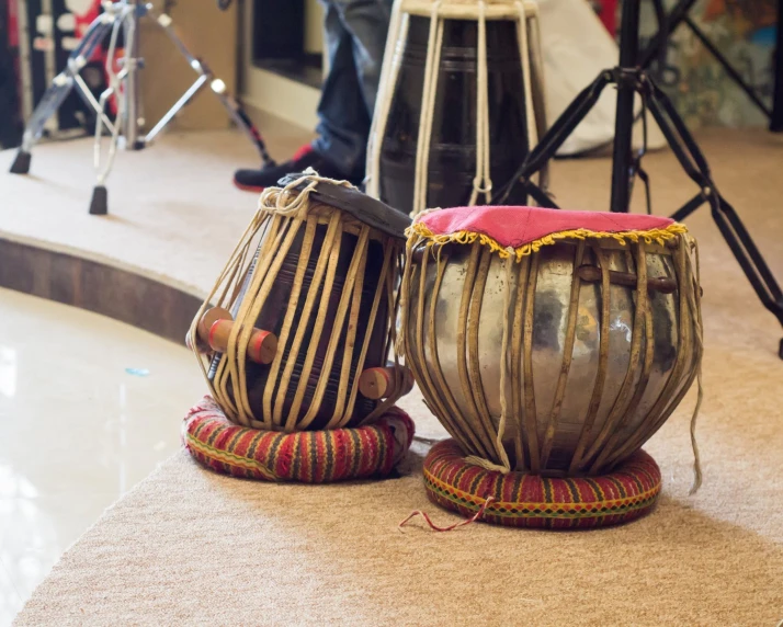 two old tablo drums with one leaning on it