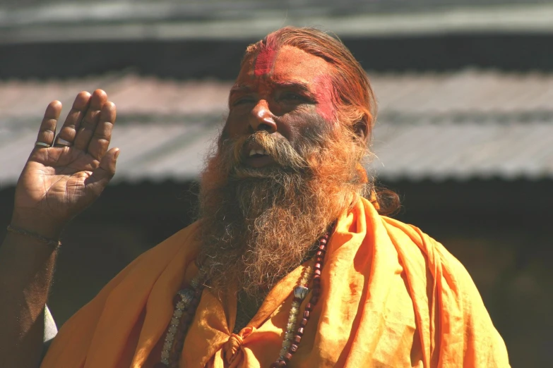 a bearded man wearing yellow and red on his body