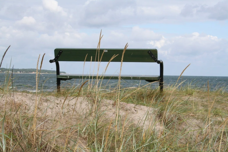 a bench sits by the water in front of it