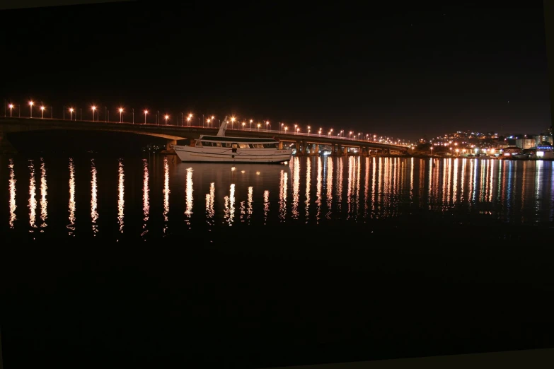a long bridge over a river at night