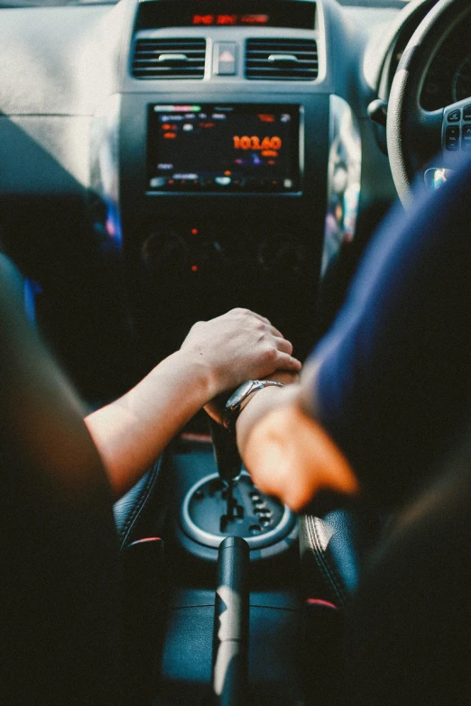 a man holding the steering wheel of a car