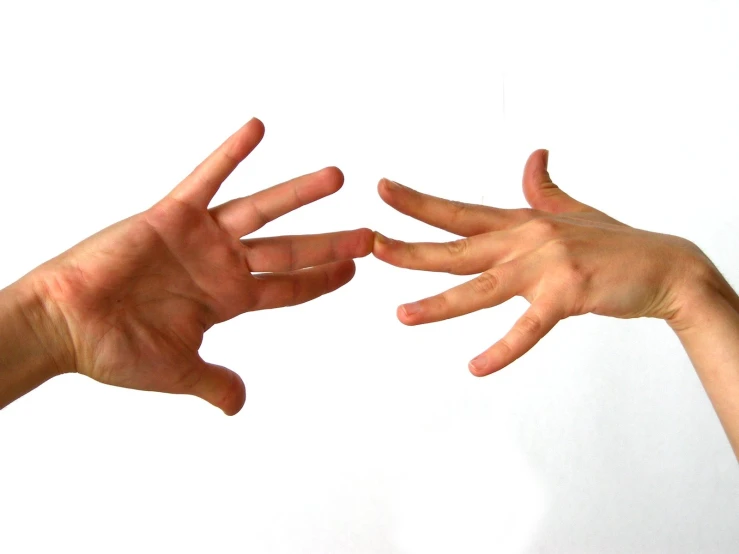 two hands reaching together toward each other to catch soing