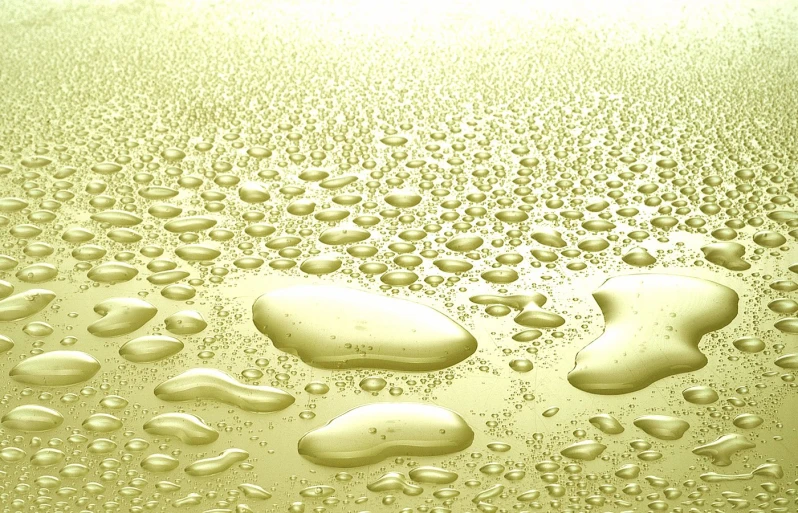 the back side of a water glass with drops on it