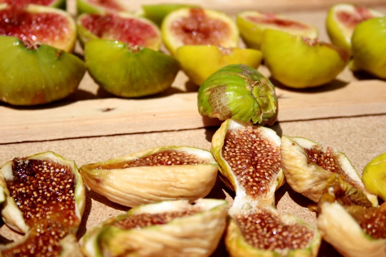 several figs with white and green fruit in the background