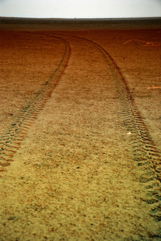 there is a tire track in the sand