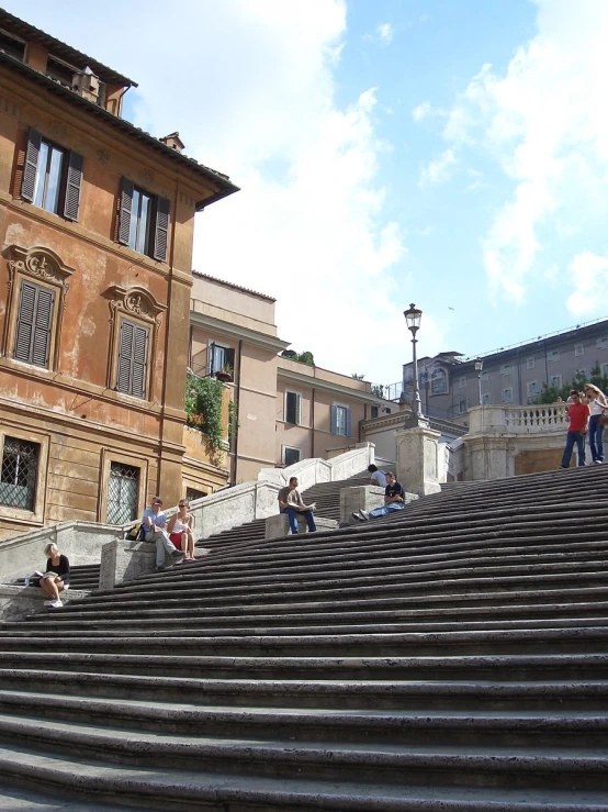 people walking down the stairs to the top of the building