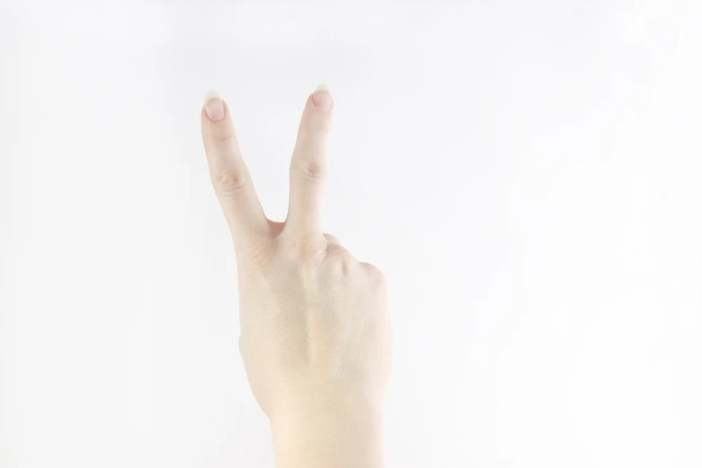 a person hand is holding up two fingers