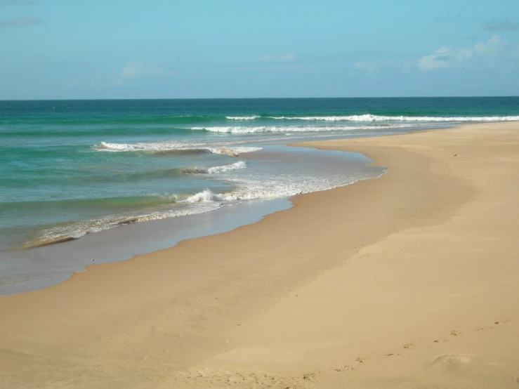 there is only one person on the ocean shoreline