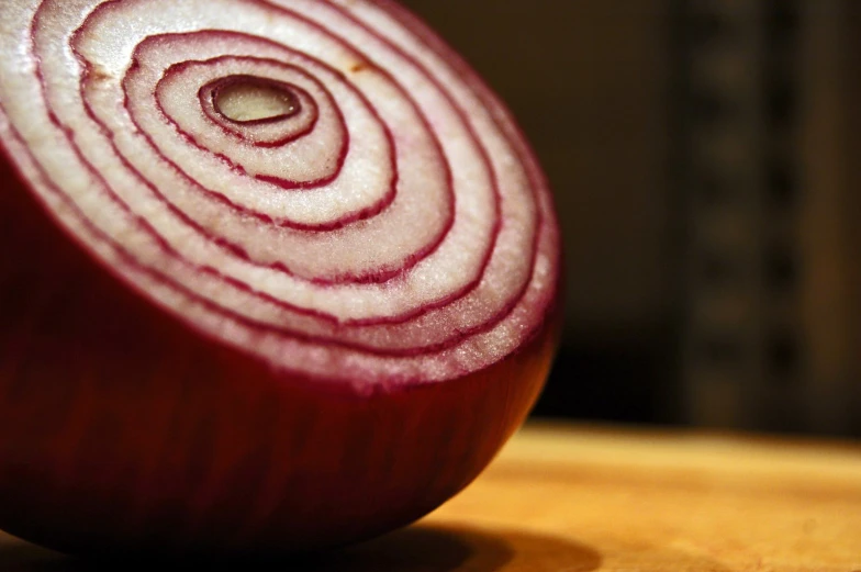 a red onion on a wooden table