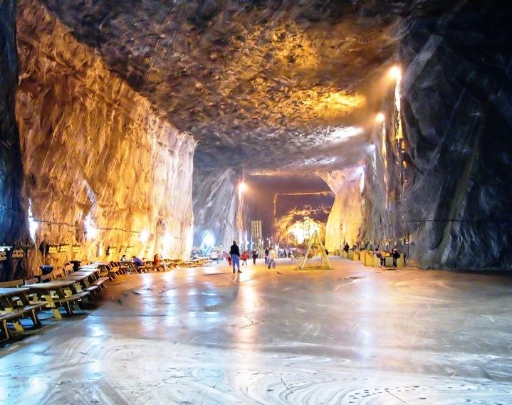 people standing in the middle of a large tunnel with stairs and benches