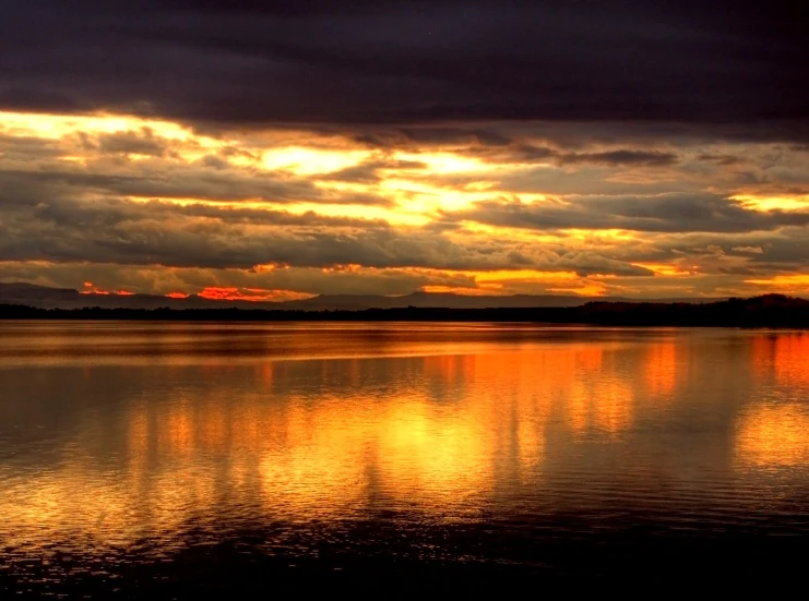 a calm river at sunset in the evening