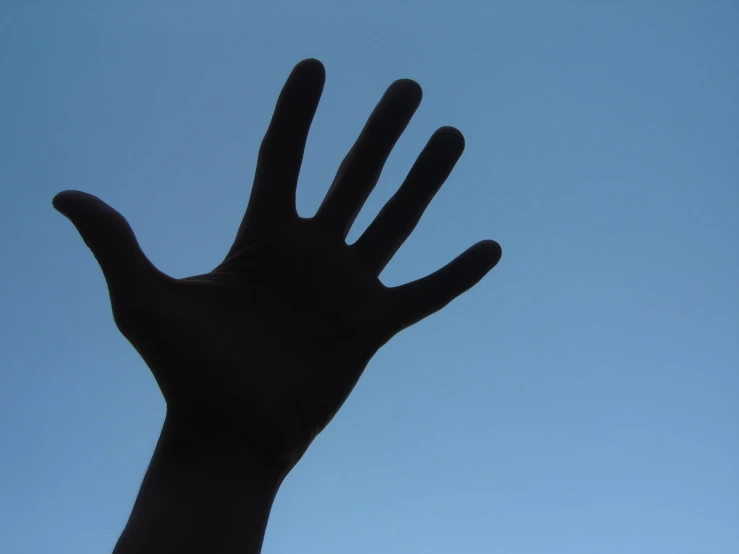 a hand reaching upward up into the air
