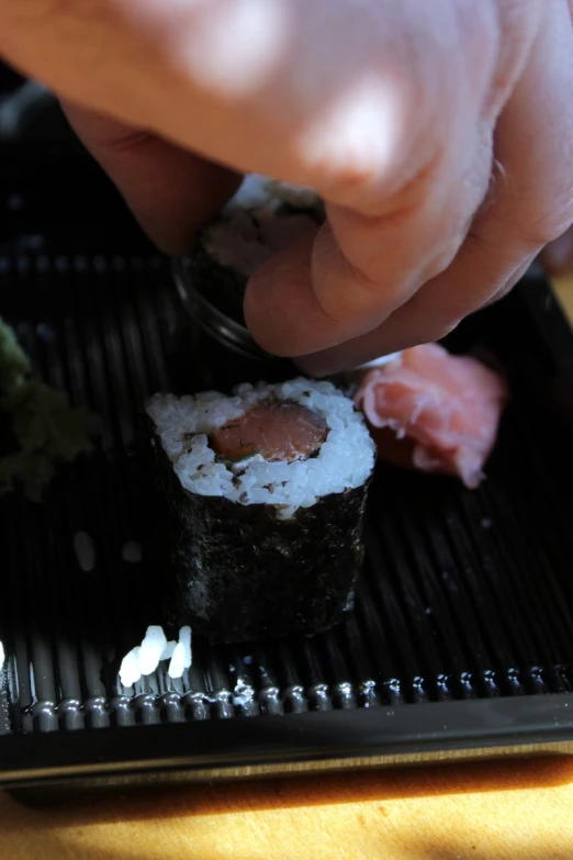 a sushi tray with salmon and shrimp on top