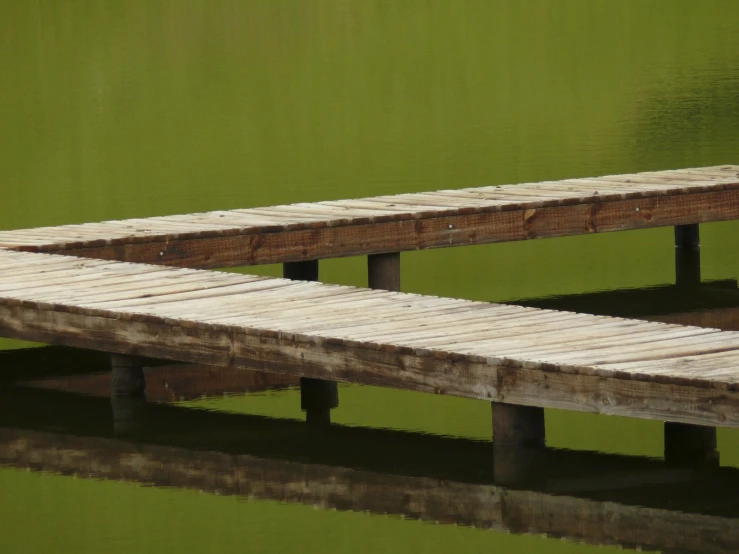 a very big pretty wooden dock by some water