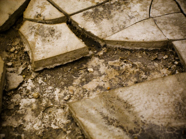 a dirty concrete floor with a  in the middle