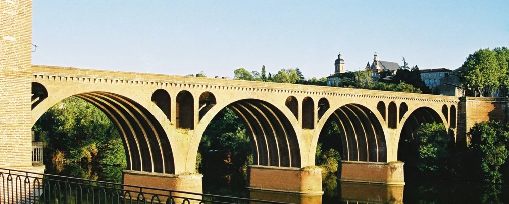 the building is next to a bridge over a river