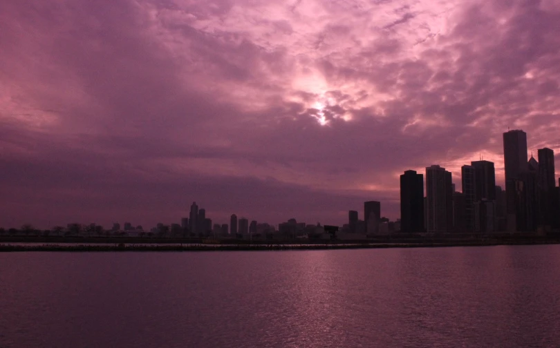 an image of a very dark city at the water's edge