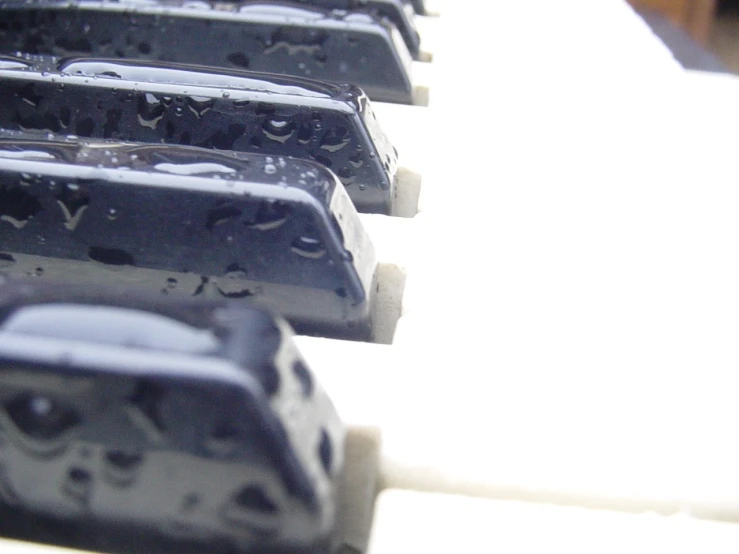 a bunch of blue and white musical instruments with water droplets on them