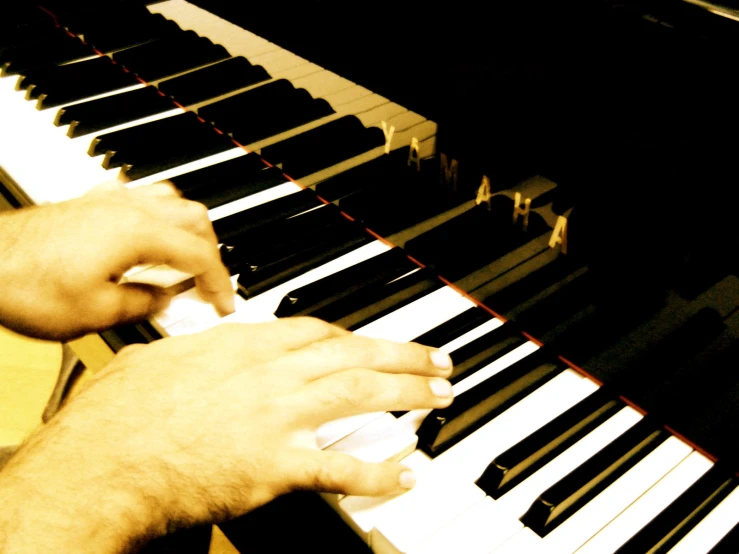 a person playing an organ keyboard in the dark