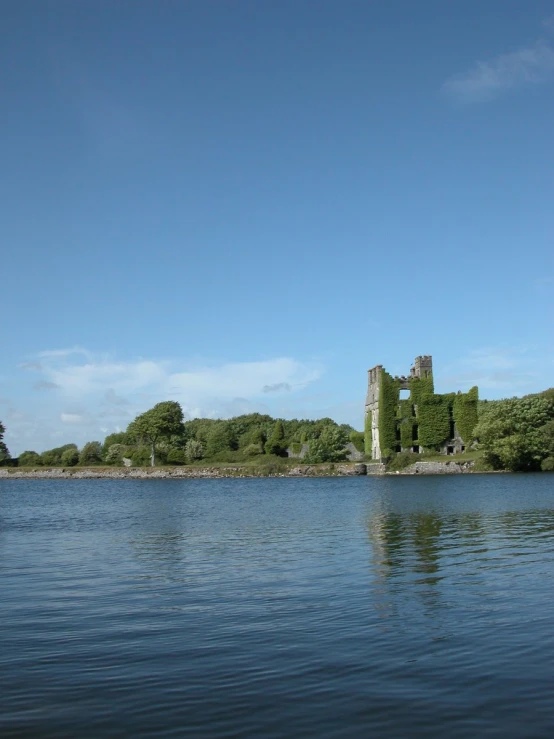 a lake with a castle in the background on a clear day