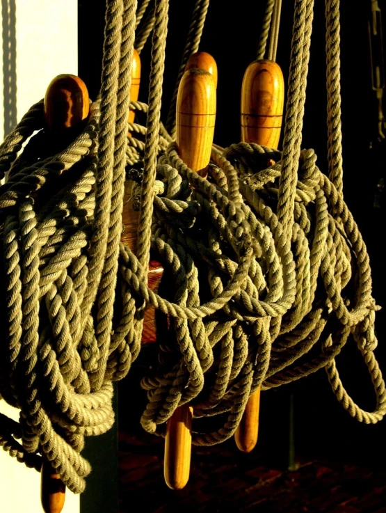 a rope and wooden hooks on the outside of a building