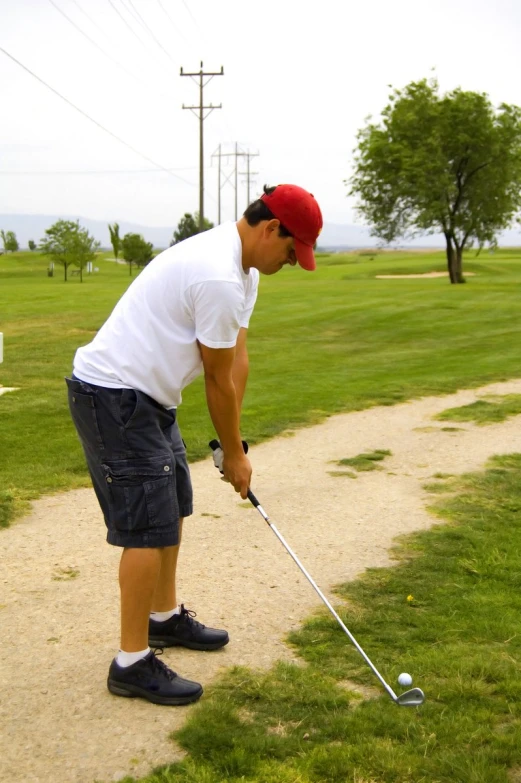 a man is in the park hitting a ball