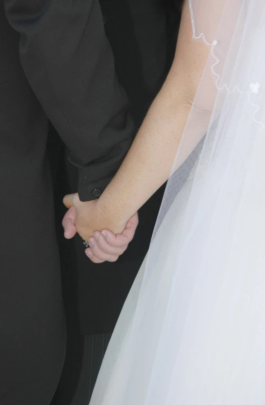 bride and groom holding hands next to each other