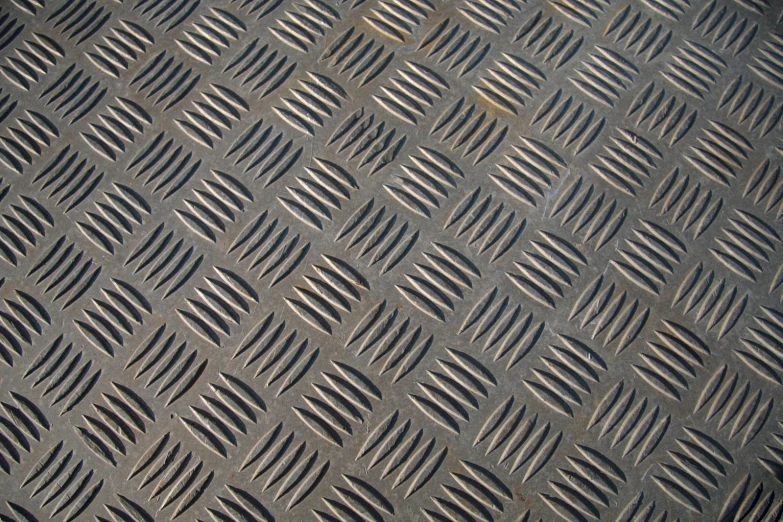 a close up of a diamond tread pattern on concrete