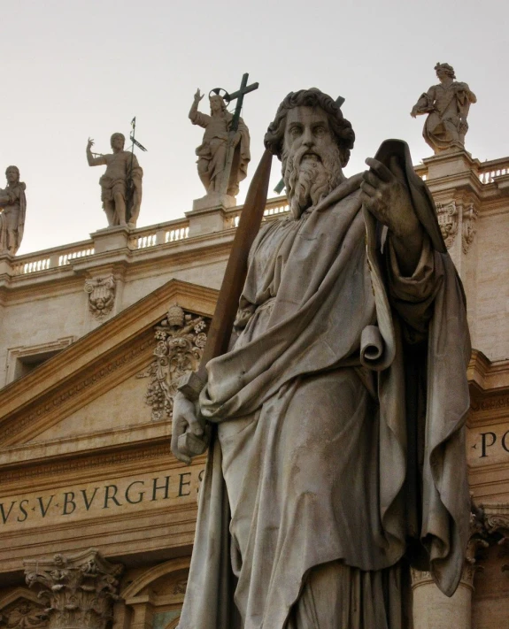 a statue standing with an angel on top