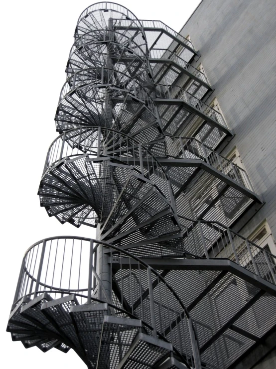 a bunch of stairs next to a tall building