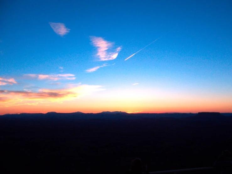 sunset with bright clouds and dark mountain tops