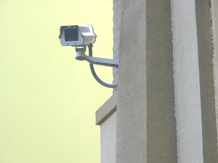 a camera attached to the side of a building