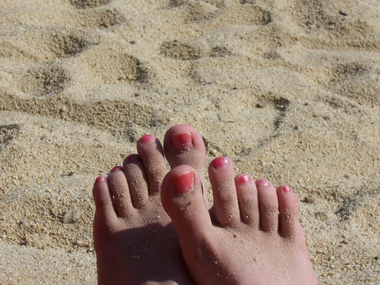 the feet and nails of someone who has red nails on