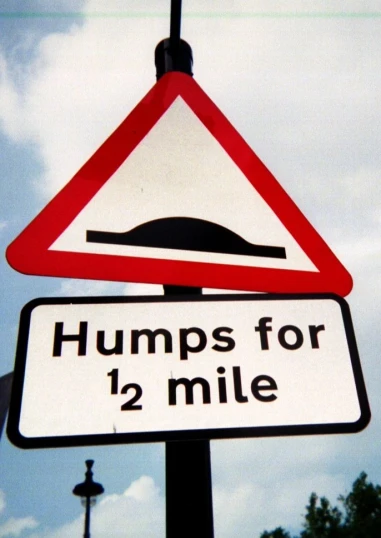 there is a traffic sign that says humps for 2 mile