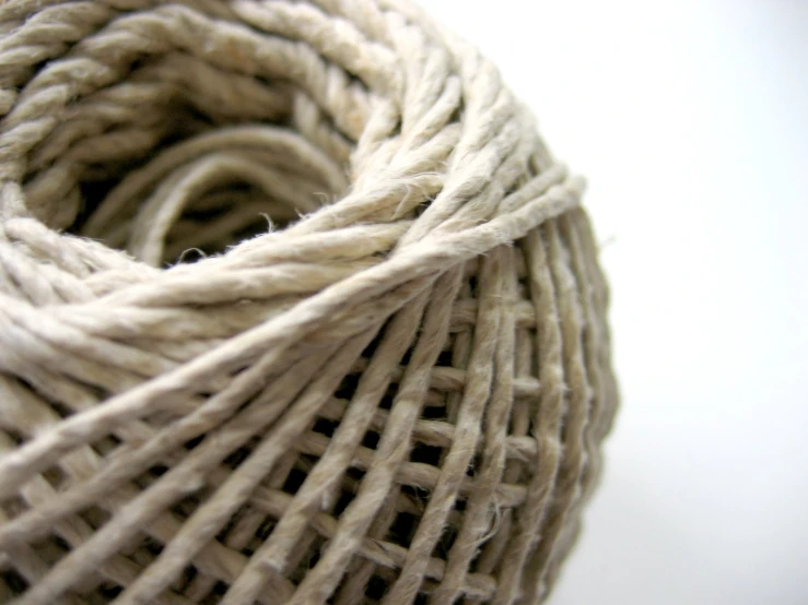 close up of the strings of a white and natural colored cotton string