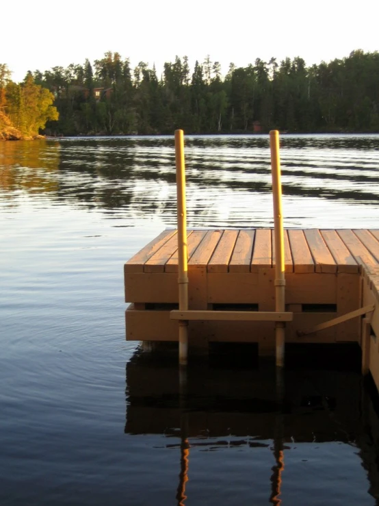 a dock with two boards on it in the water