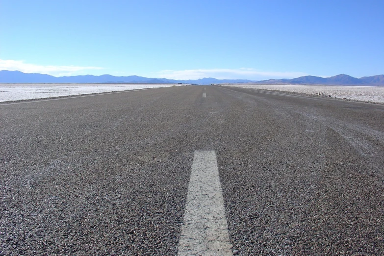 a long stretch of asphalt surrounded by mountains