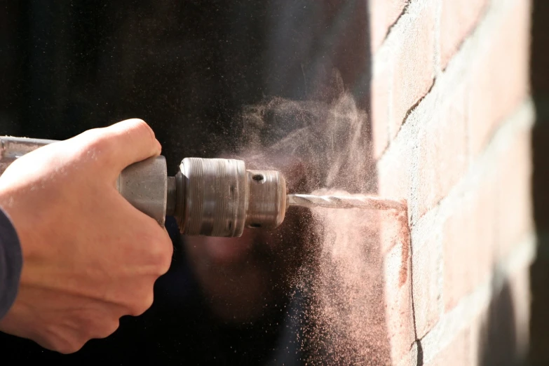 a man working with a pipe with a machine