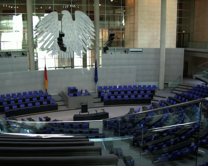 a blue chair in the center of a circular stage