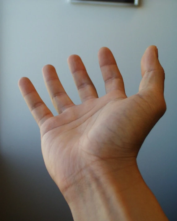 someone holding their hand in front of a tv