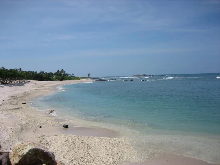 an empty beach is seen on a sunny day