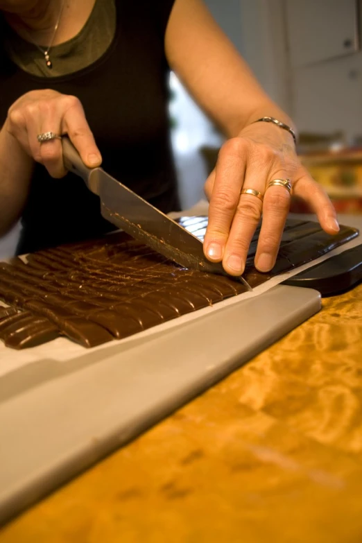 a woman is  cake using a knife