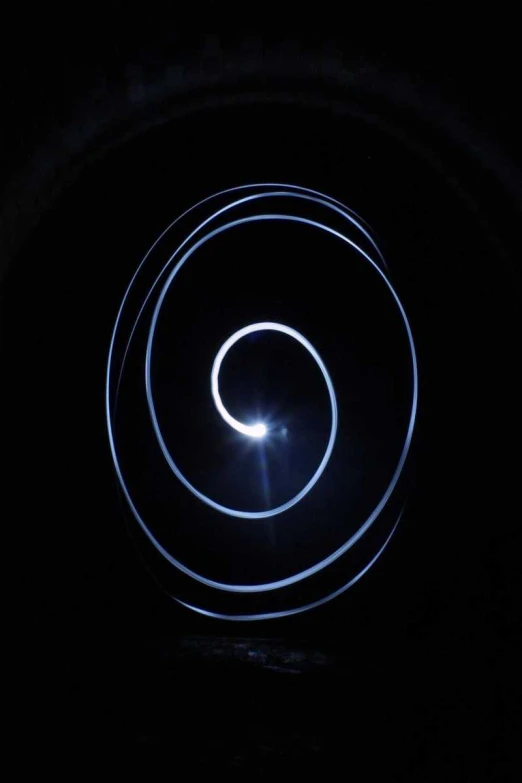a blue spiral swirl that is in the dark