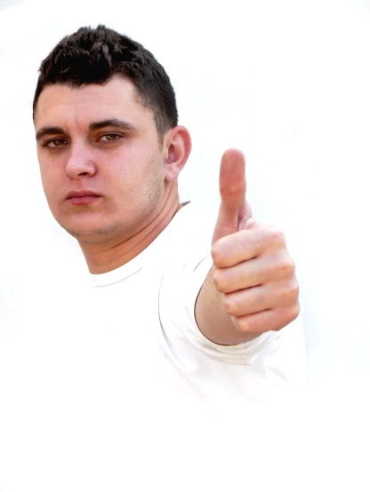 a young man thumbs up while looking at the camera