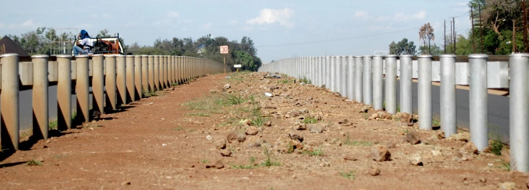 there is an empty road with posts and wires