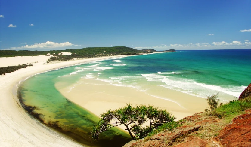 an ocean beach with white sand and clear turquoise water