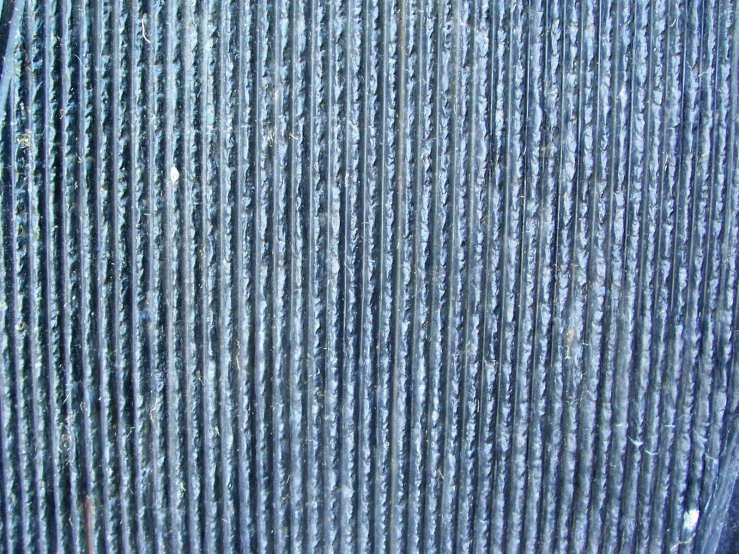 a close up po of metal mesh that looks like it is coated with water drops