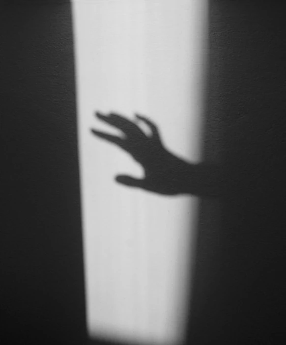 shadow of a hand casting on a wall