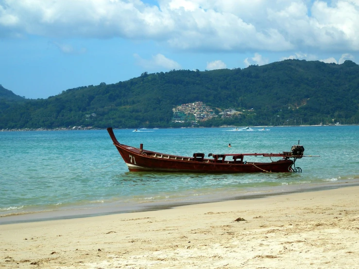 a small boat sitting out on the sand