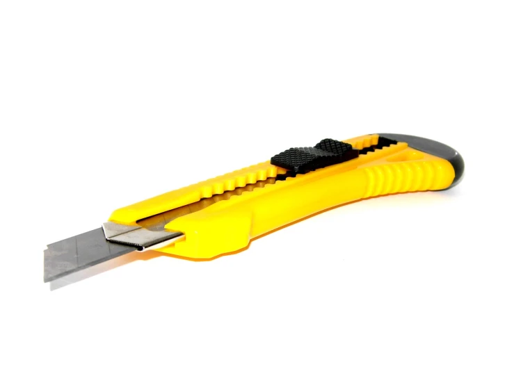 an open yellow knife has black handles on it